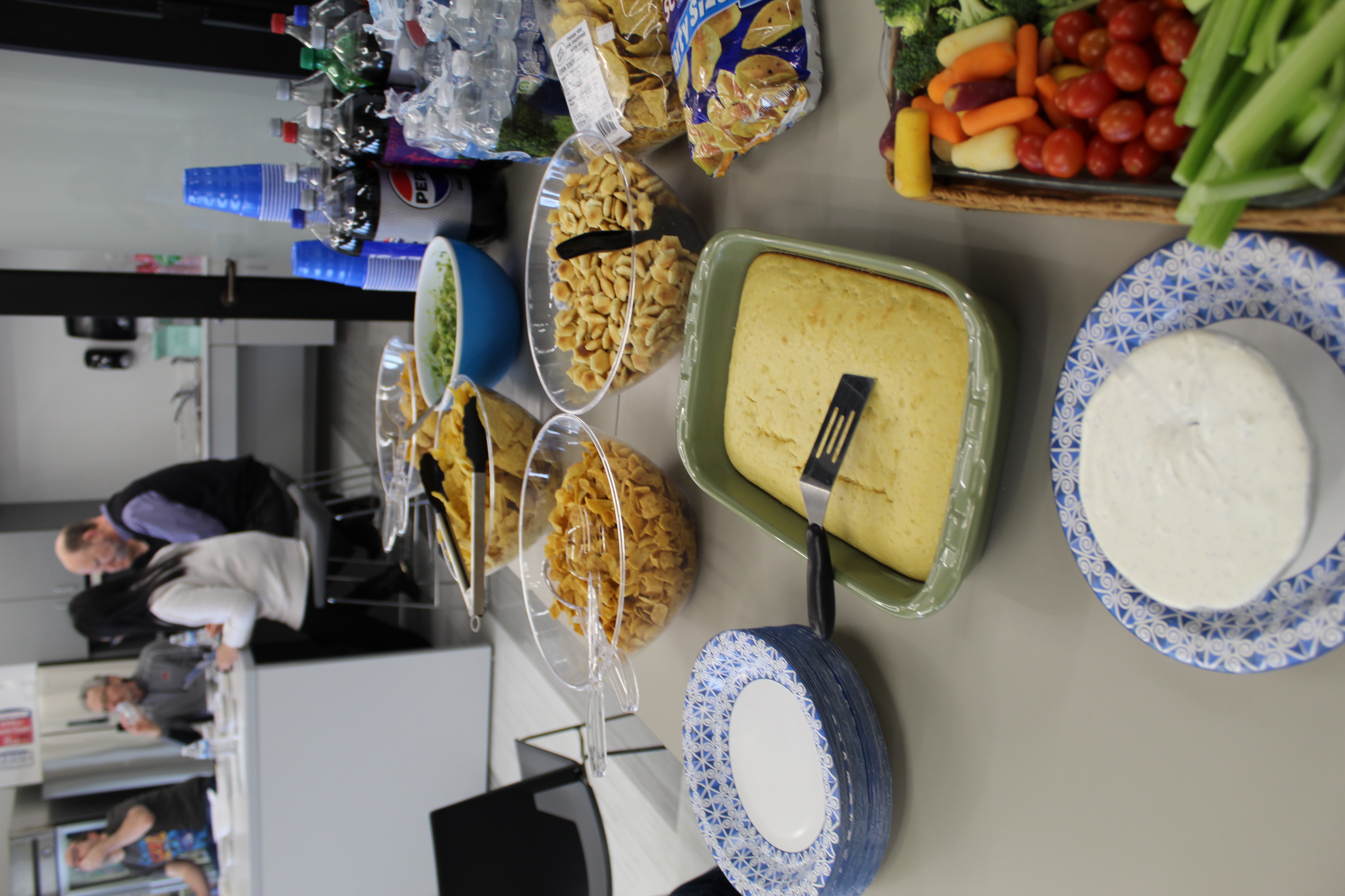 A snack table with chips, guac, cornbread, and other delights