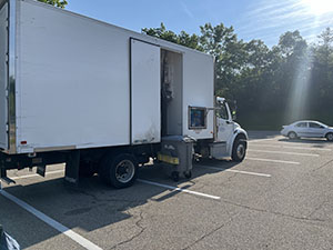 a huge white shredding truck under a blue sky