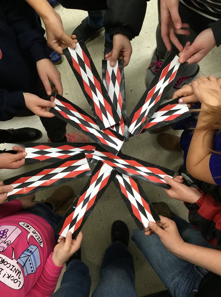 Children hold their bookmarks in a spoke pattern