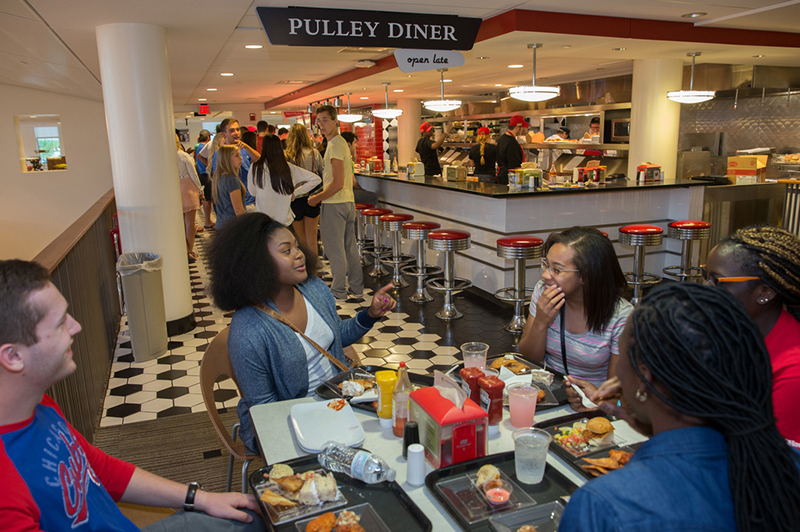 A group of students talk over snacks at the pulley diner