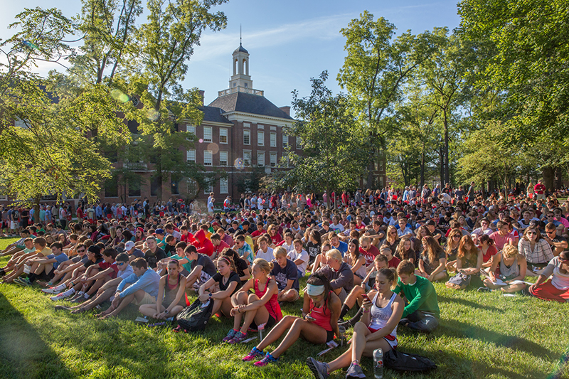The first-year class sits on the lawn on academic quad