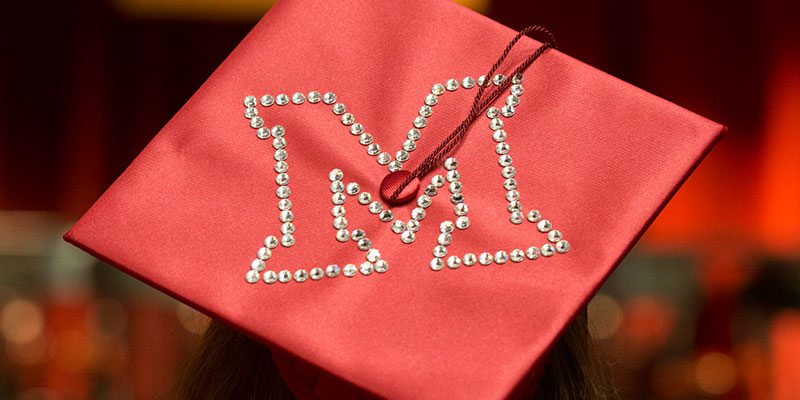 Photo of graduation cap with the Miami M.