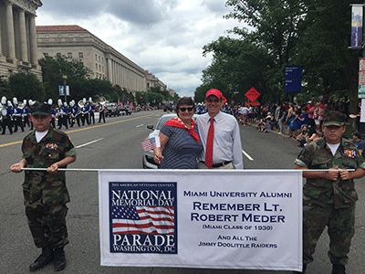 David and Valerie Hodge with Miami banner at Memorial Day parade in D.C.