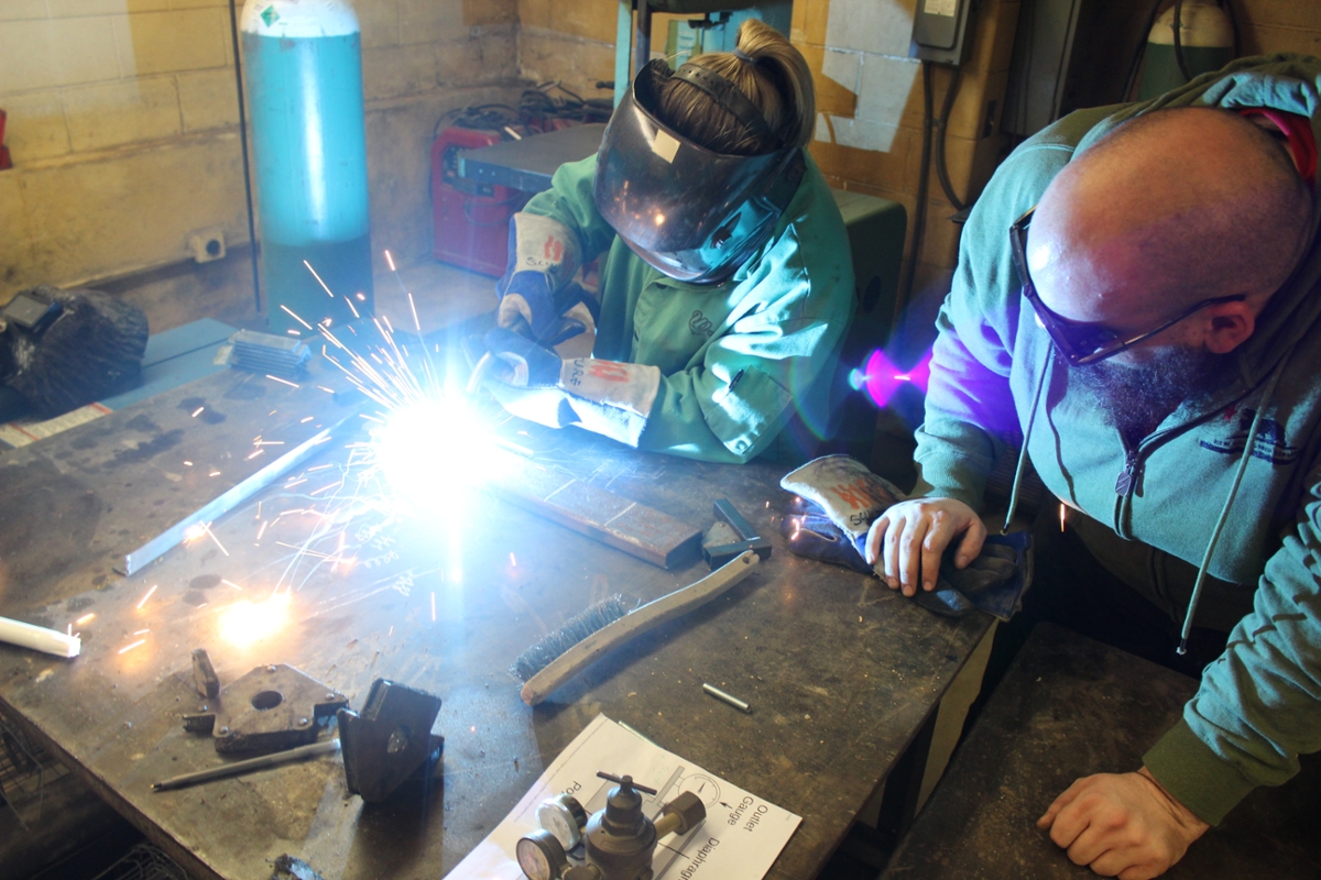 Miami advanced sculpture students welding to fabricate 'Sound of Music.'