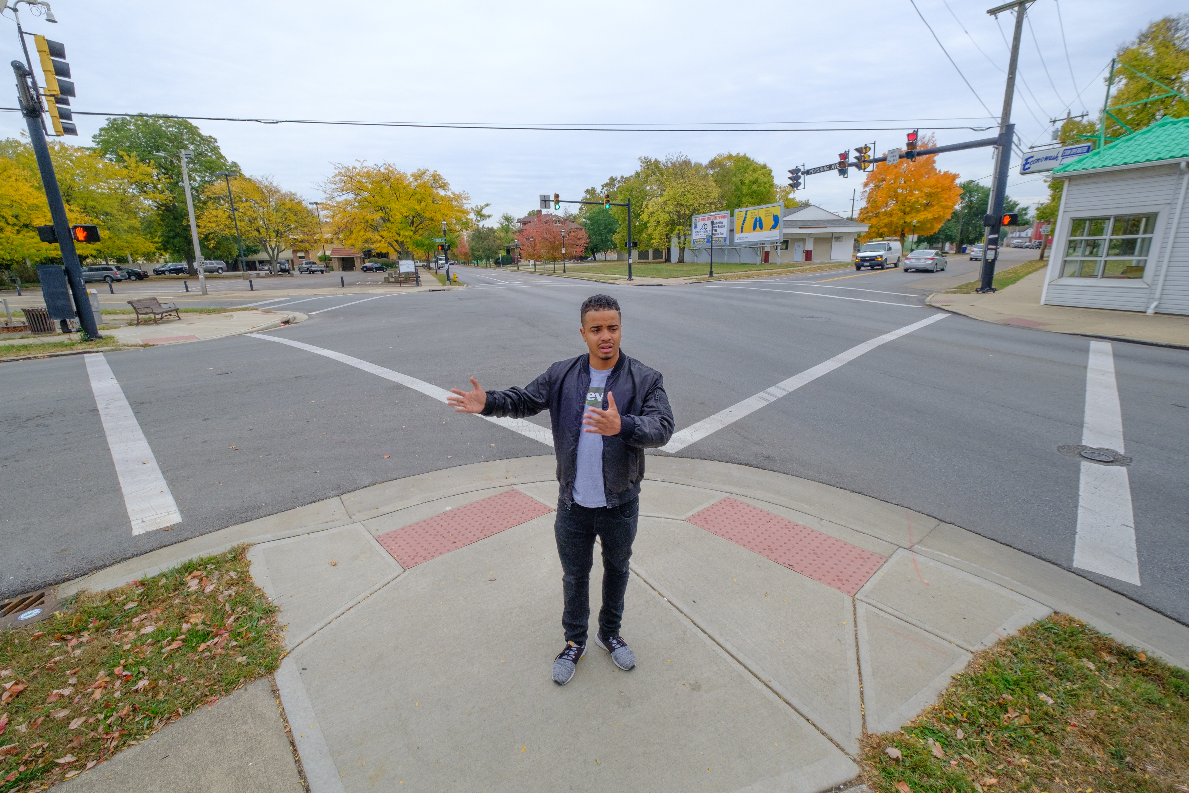 Ready stands at the five points intersection and explains proposed changes.