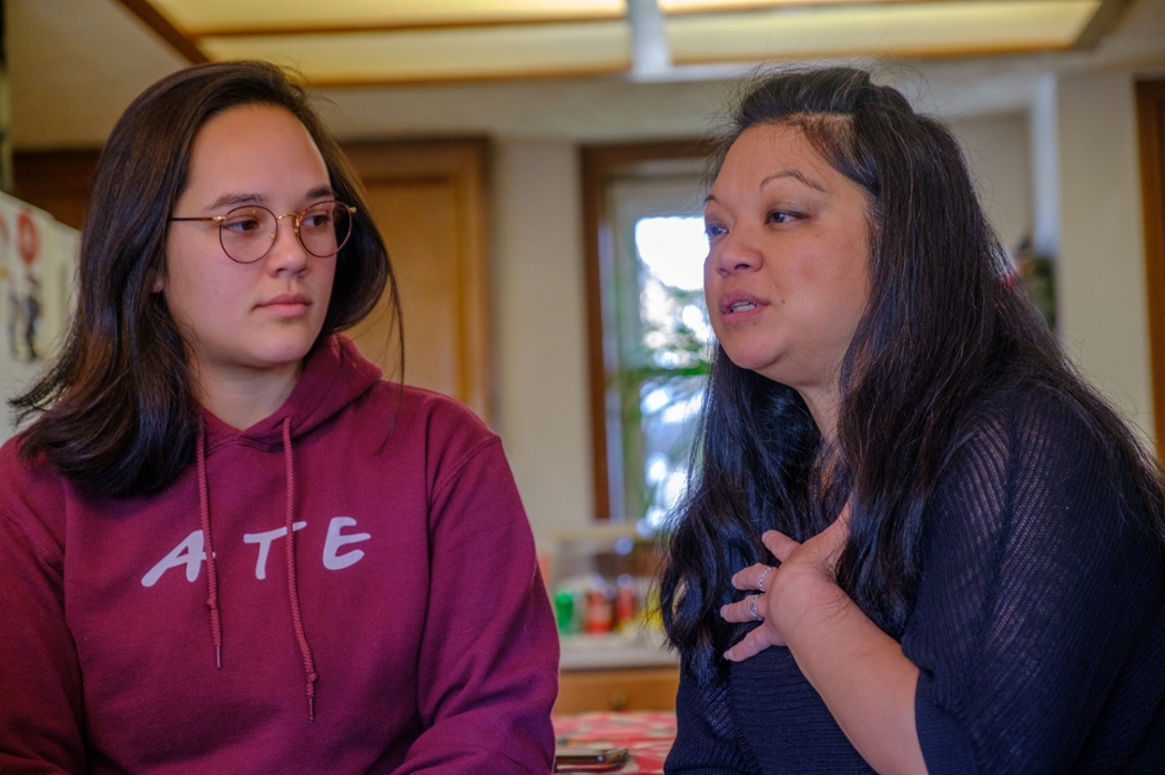 Addie Joson and her mom, Charmaine, sit at the kitchen counter.