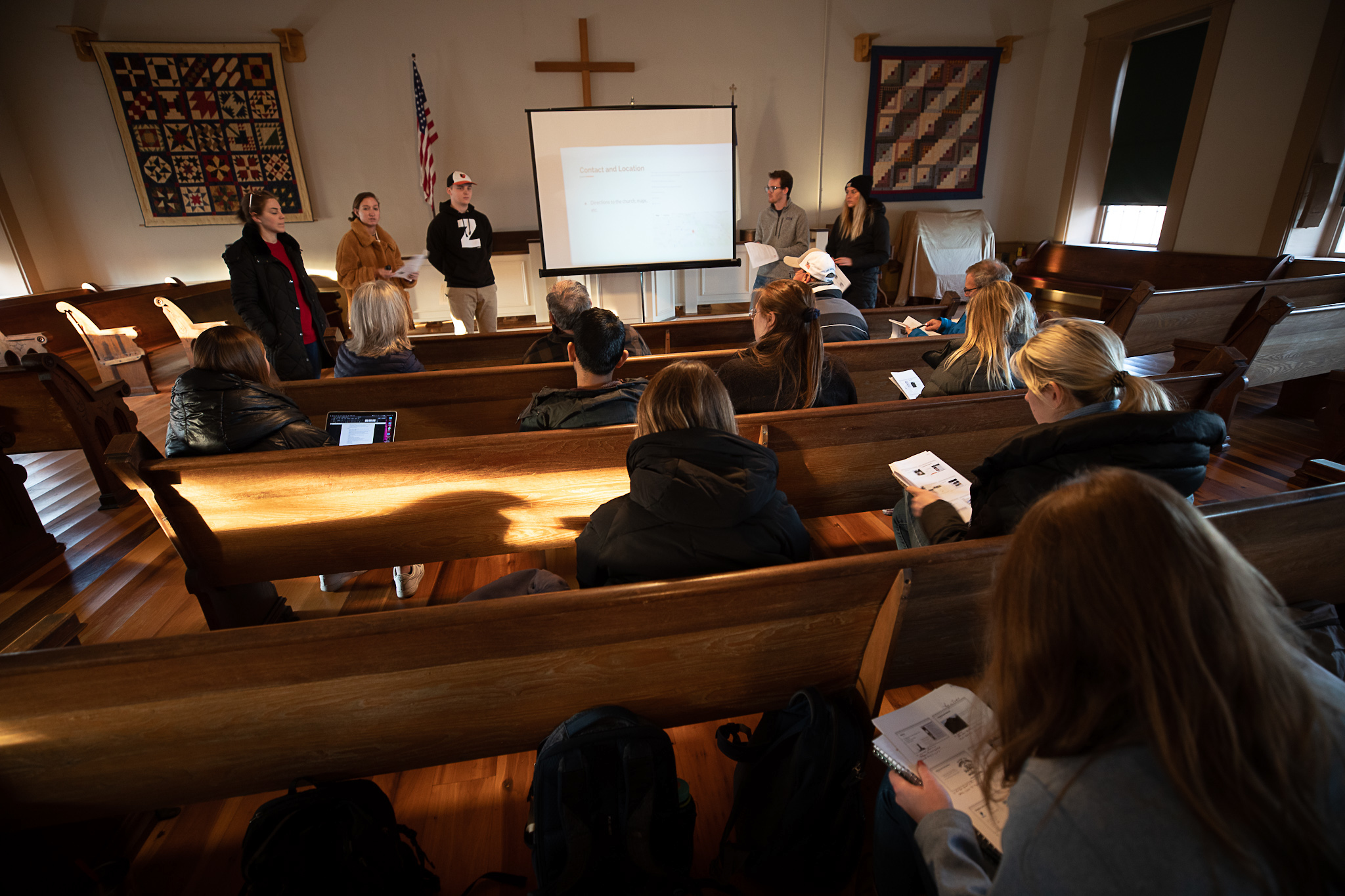 Miami students present ideas to HHC trustees inside the church sanctuary.