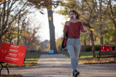 A student wears a mask on campus