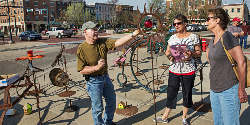 People viewing sculptures for sale in uptown Oxford