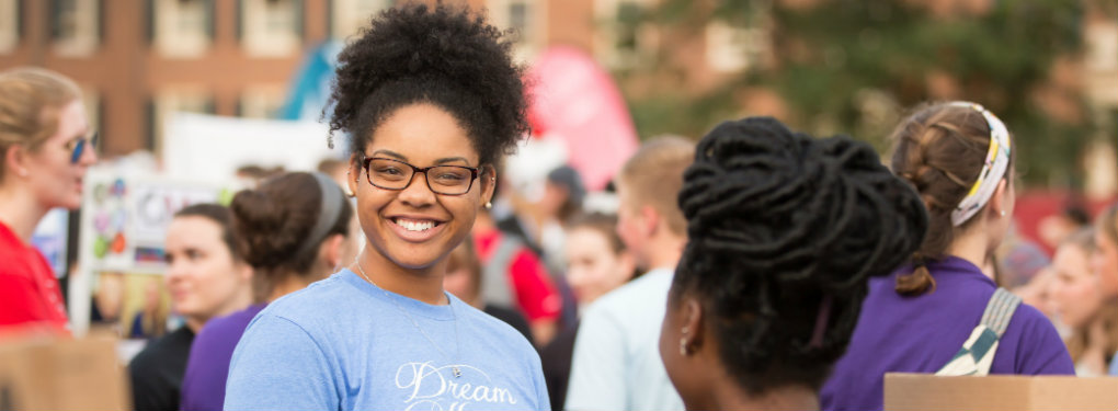 Female student outside wearing a Dream Keepers shirt