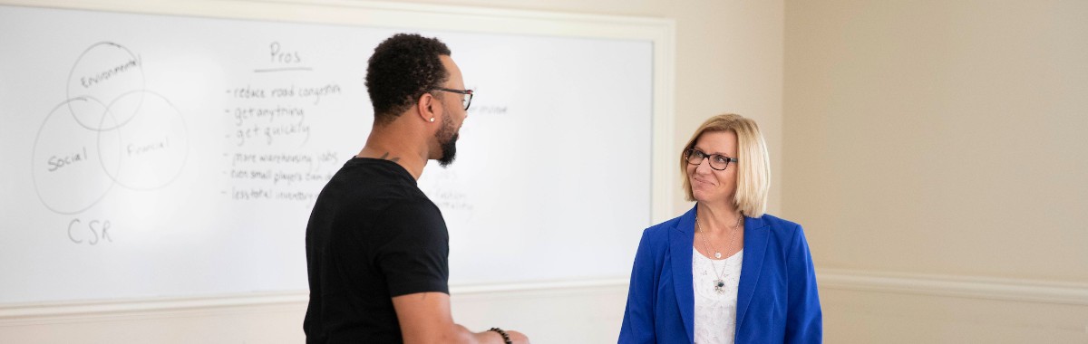  FSB's Professor Ellram converses with student in her class