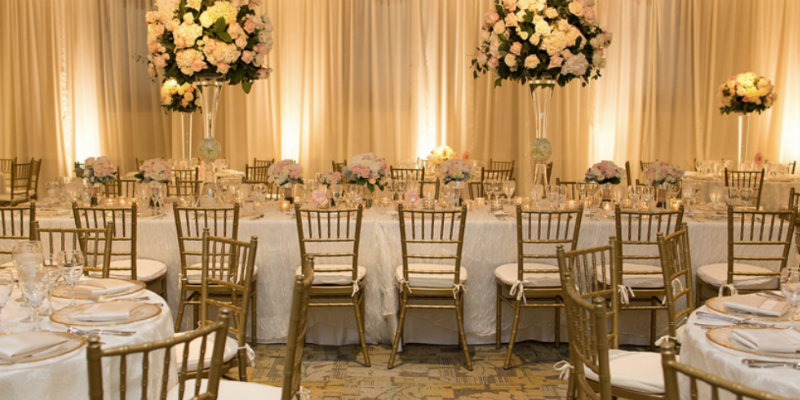 Shown is a photo of a event hall set up for a wedding