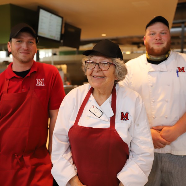  Three dining employees smiling for a photo.