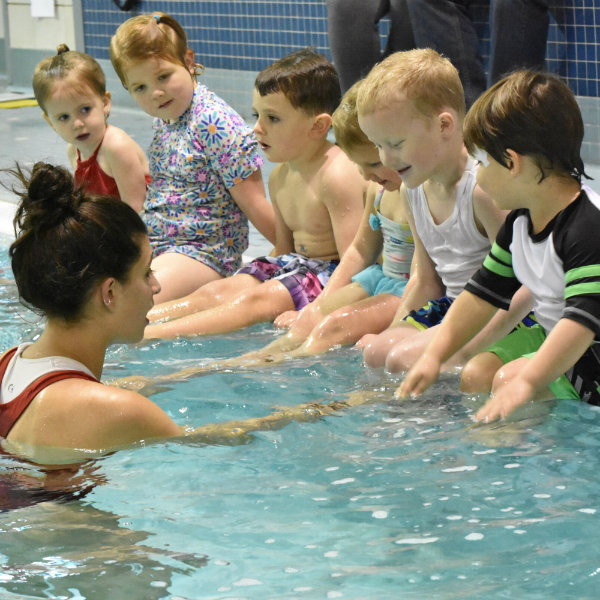 Shown is a photograph of a child learning to swim.