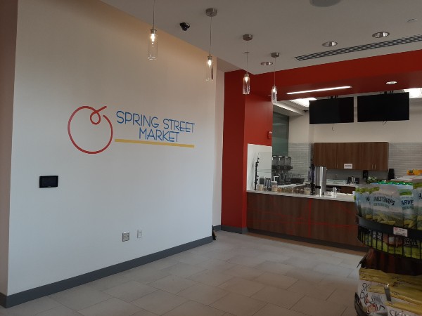 Spring Street Market logo installed on the wall.