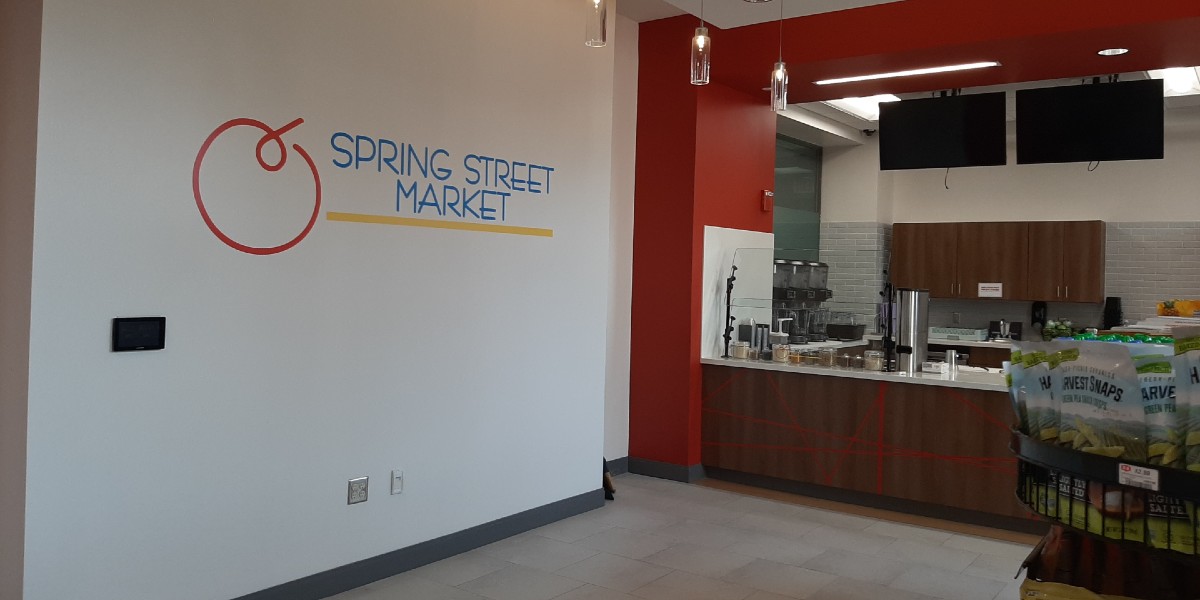 Spring Street Market logo installed on the wall.