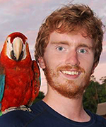 photo of Jason Connel Young with parrot friend