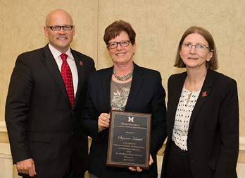 Suzanne Kunkel, with President Greg Crawford and Provost Phyllis Callahan, after receiving the Distinguished Professor Award