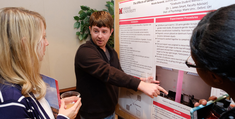 A student presents a research poster