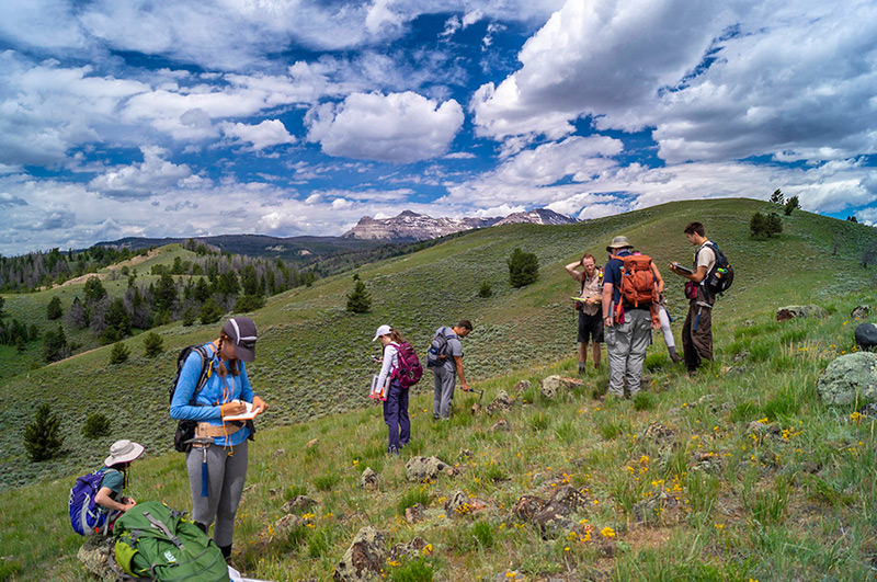 students and faculty during a field geology course exploring outside