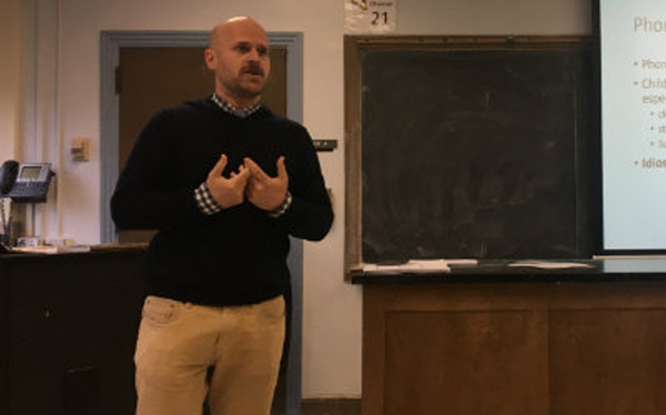 Aaron Sheild lectures to a group.