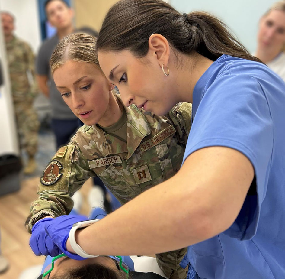 Patient with Blood pressure cuff on their arm as nurse places stethoscope on elbow to listen to heartbeat