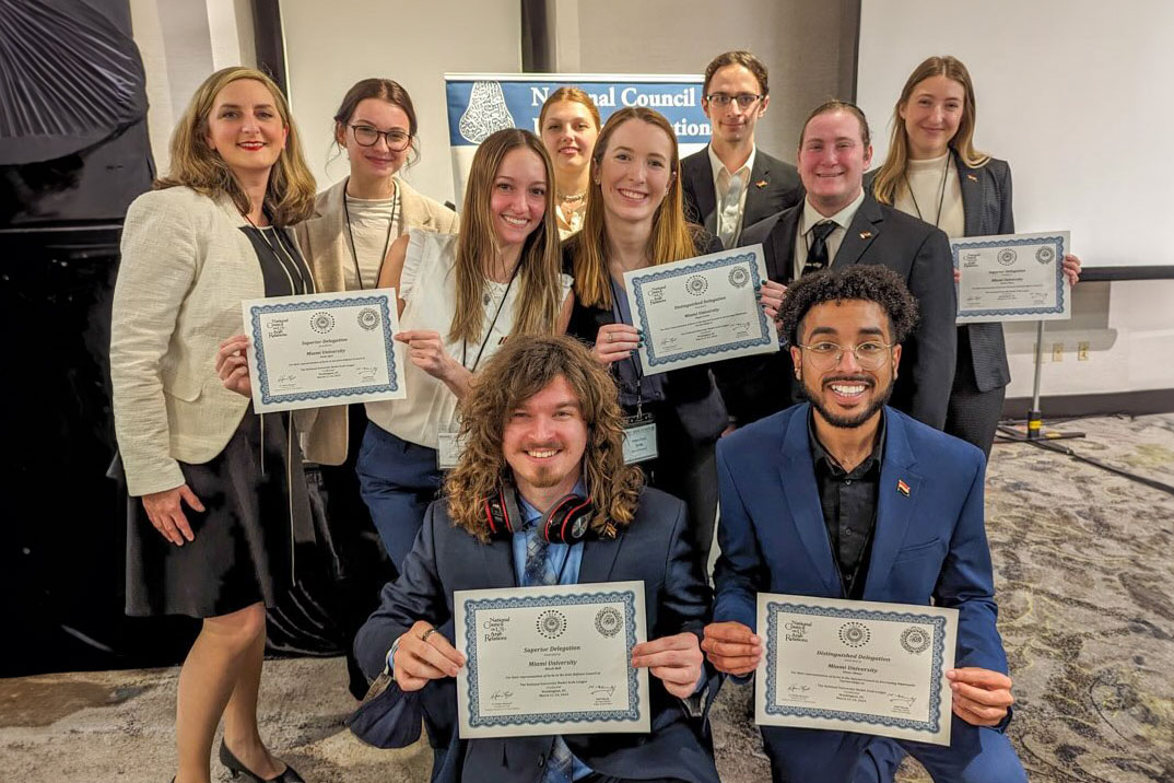 The student members of Miami's Model Arab League pose at the ceremony near Washington, DC along with their advisor, Shawn Vanness (left).