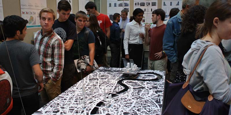  Visitors mill around a tabletop rendering of a map of London