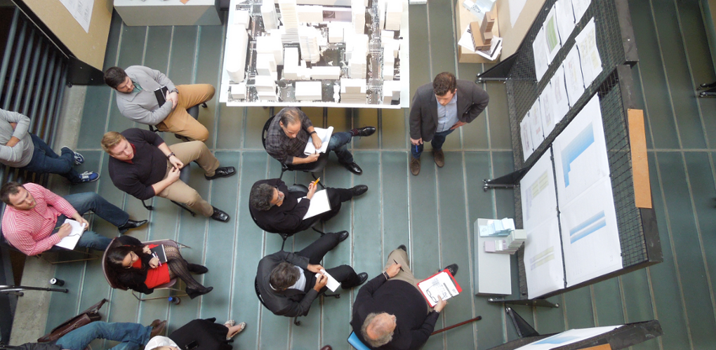  An overhead view of a student presenting to faculty