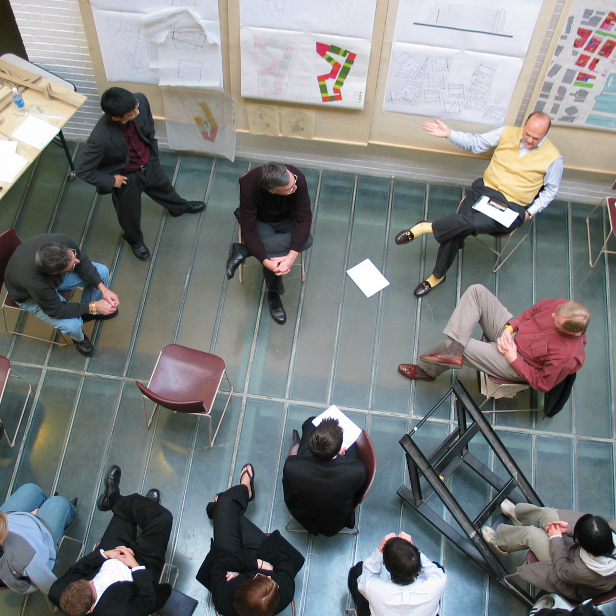 overhead view of a student's work being critiqued in the atrium of Alumni Hall