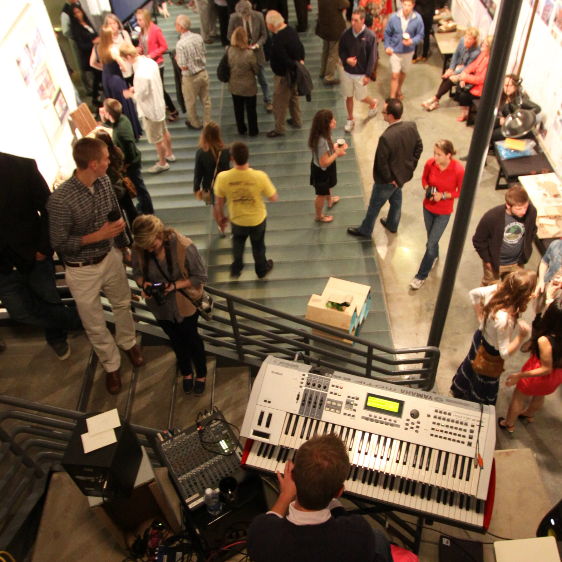 atrium full of people at open house with keyboard in the foreground