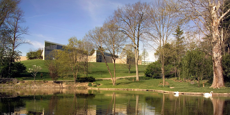 A view of the Art Museum exterior as seen from the pond 