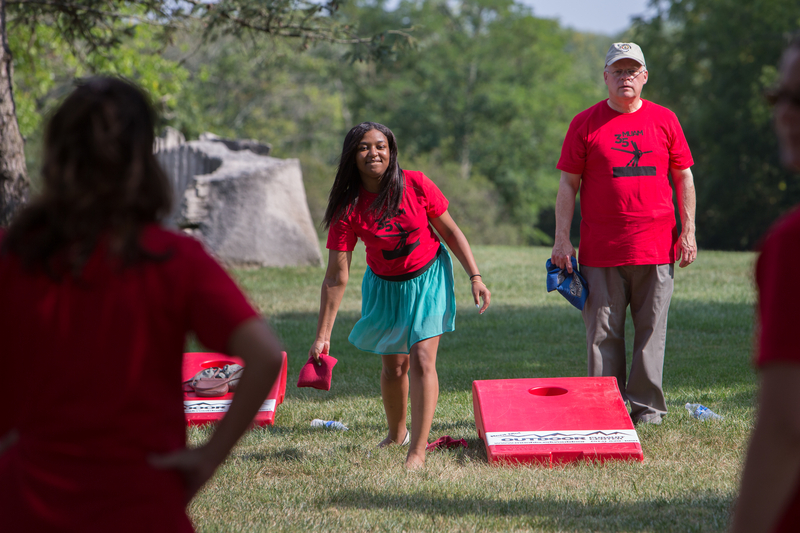  People play cornhole at the lawn party