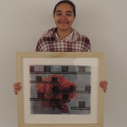 Student artist Ashley Jackson holds one of her paintings