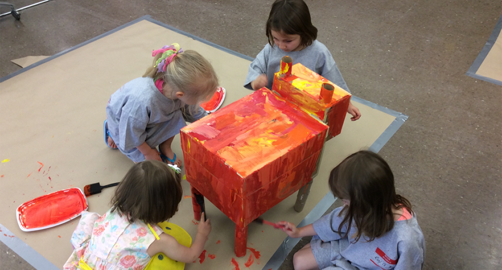 Four children paint a colorful project 