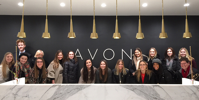 students visiting Avon company