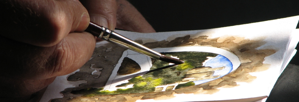 Fingers using a brush to create a watercolor painting of a landscape