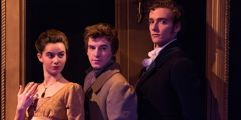 Three actors with sly expressions pose in a scene from Miami Theatres production of Pride and Prejudice