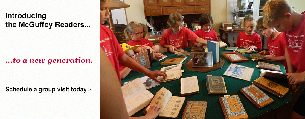  A group of children examine McGuffey readers on the famous hexagonal table. Text: Introducing the McGuffey Readers to a new generation.