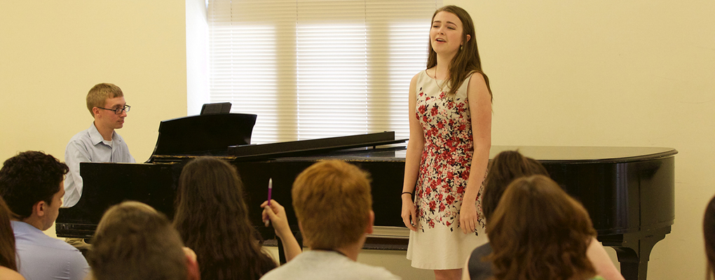  An accompanist and voice student perform for the class