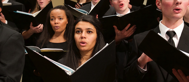 Closeup of a section of singers in a Glee Club Collegiate Chorale joint concert