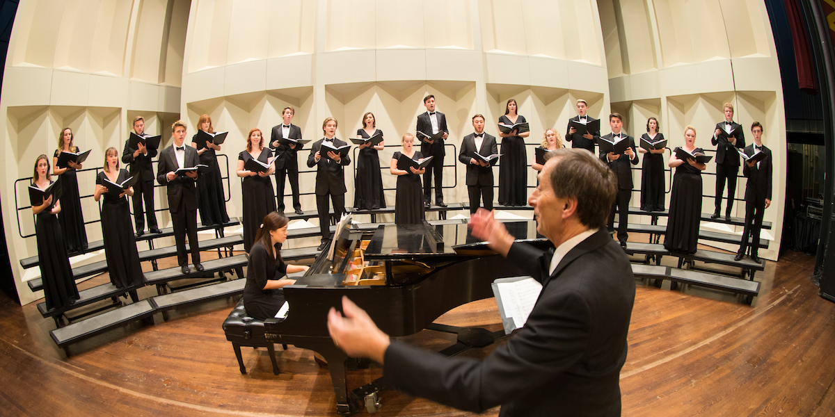  Fisheye view of the chamber singers onstage at Hall Auditorium, including conductor and accompanist