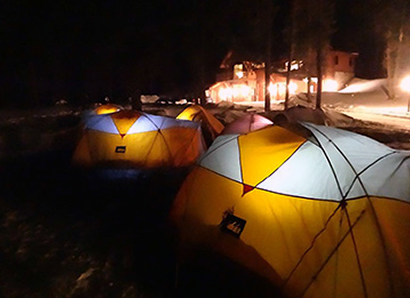 Internally lit tents at night in the snow