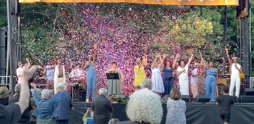 Cast of Sound of Black Music with confetti raining down on an outdoor stage