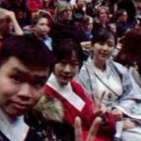 Students in the audience look at the camera
