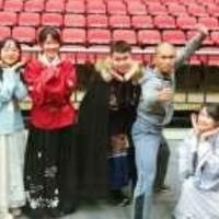 Students pose with Chinese Warriors performer