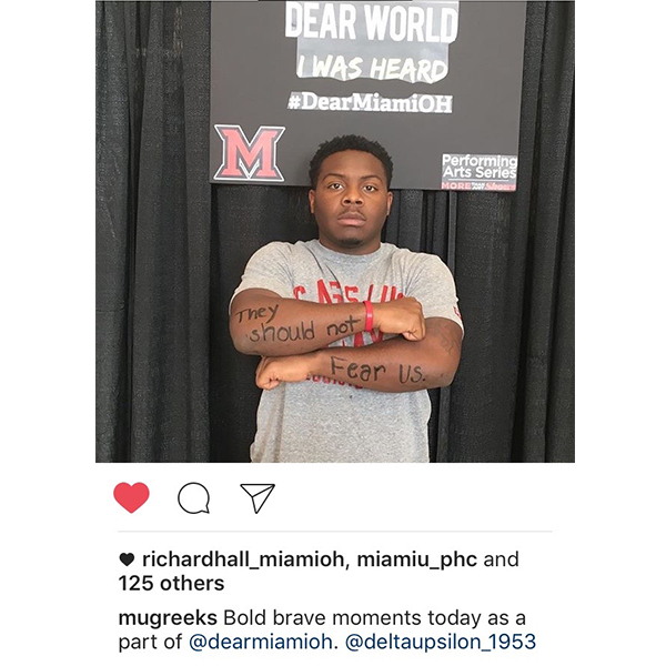  Instagram post by mugreeks Bold brave moments today as a part of @dearmiamioh. @deltaupsilon_1953. Student with hands crossed with “They should not Fear us” written on his arms.
