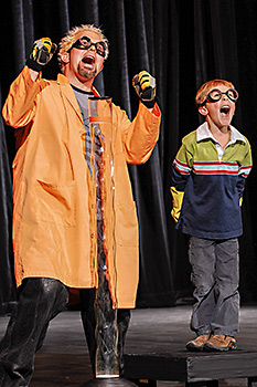Doktor Kaboom on stage with child audience member