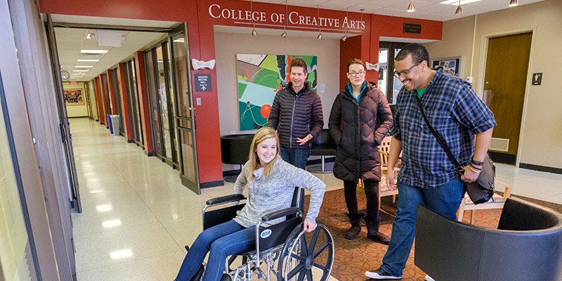 students using a wheelchair in a building to study usability