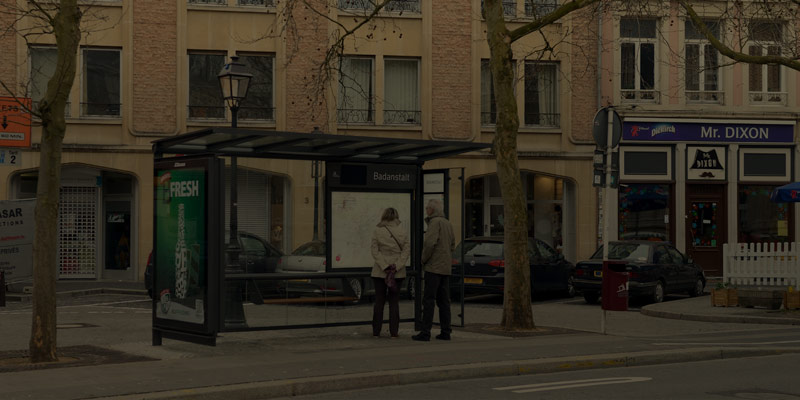people waiting at a bus stop